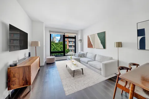 a living room with furniture fireplace and a flat screen tv