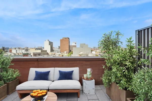 a outdoor sitting area with a couch and trees
