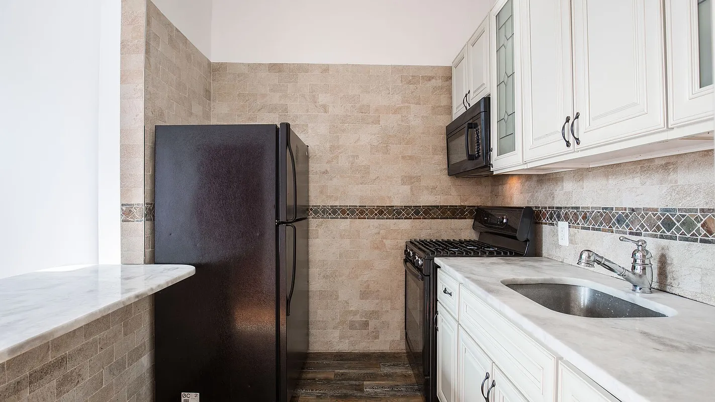 27 Brevoort Place, Unit 2 Brooklyn, NY 11216 - Photo 4 of 9 a kitchen with stainless steel appliances granite countertop a refrigerator and a sink
