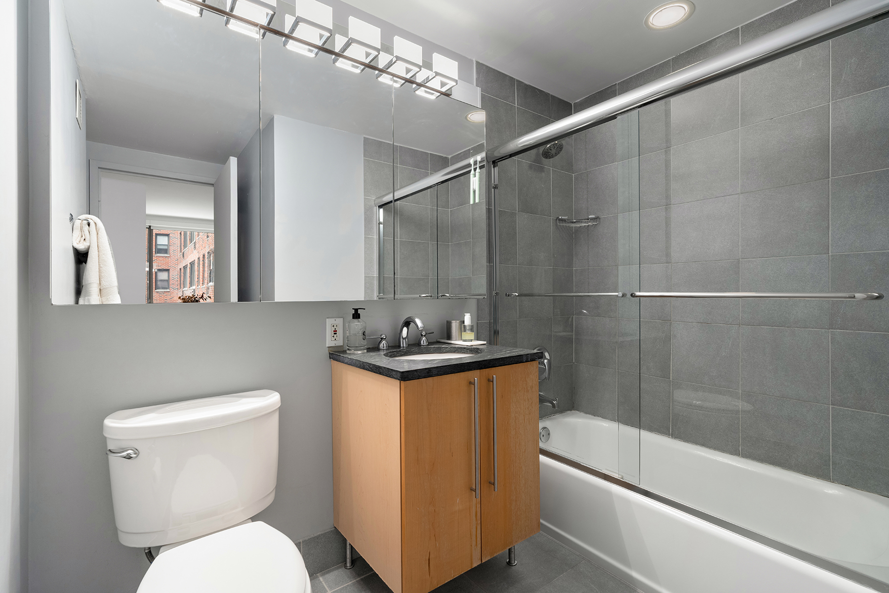 242 East 25th Street, Unit 3A Manhattan, NY 10010 - Photo 8 of 9 a bathroom with a toilet a sink and bathtub