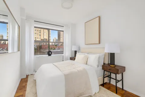 a bedroom with a bed and a window