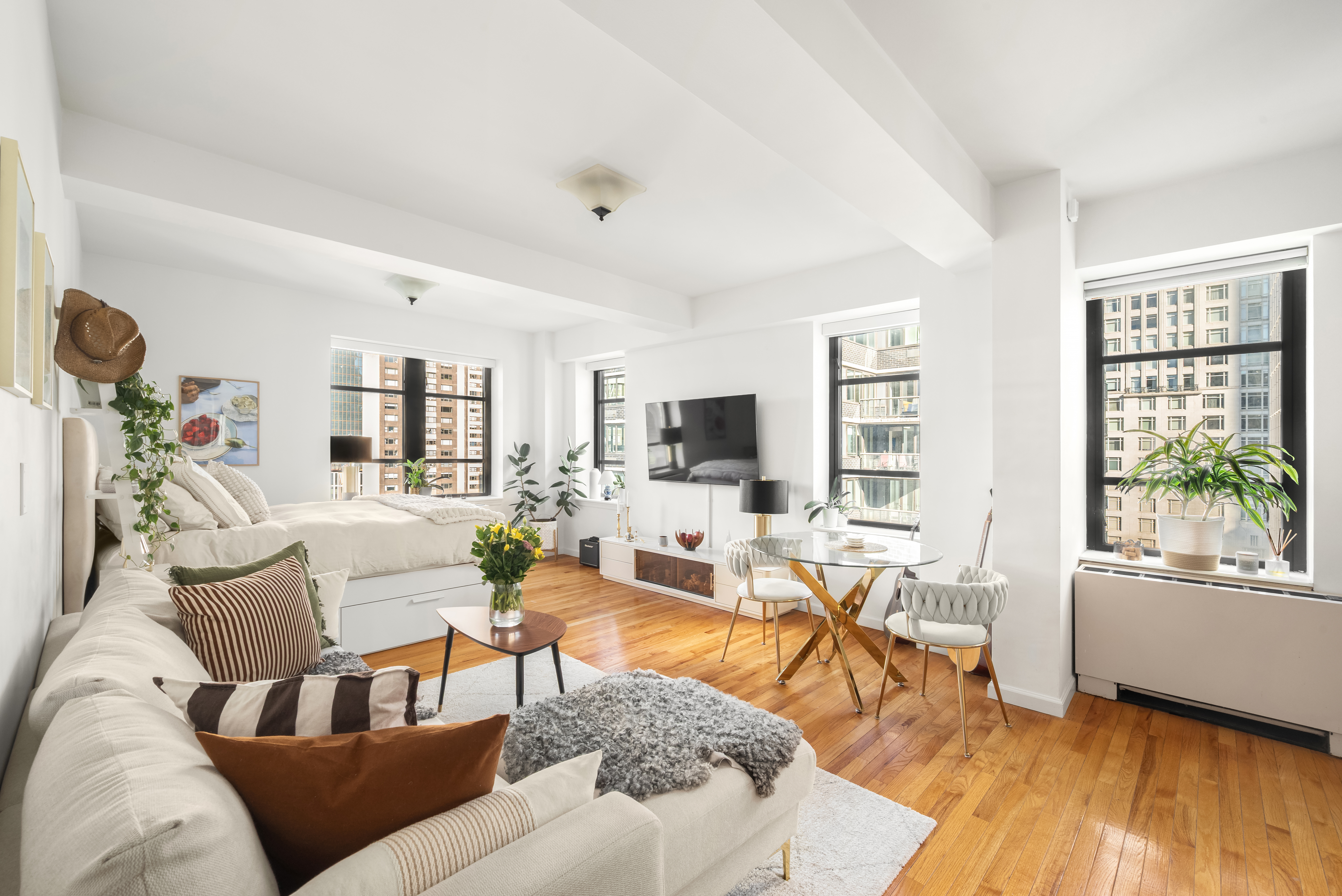 43 West 61st Street, Unit 24Y Manhattan, NY 10023 - Photo 1 of 6 a living room with furniture and a large window