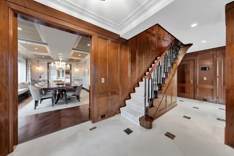 a view of entryway and hall with dining room
