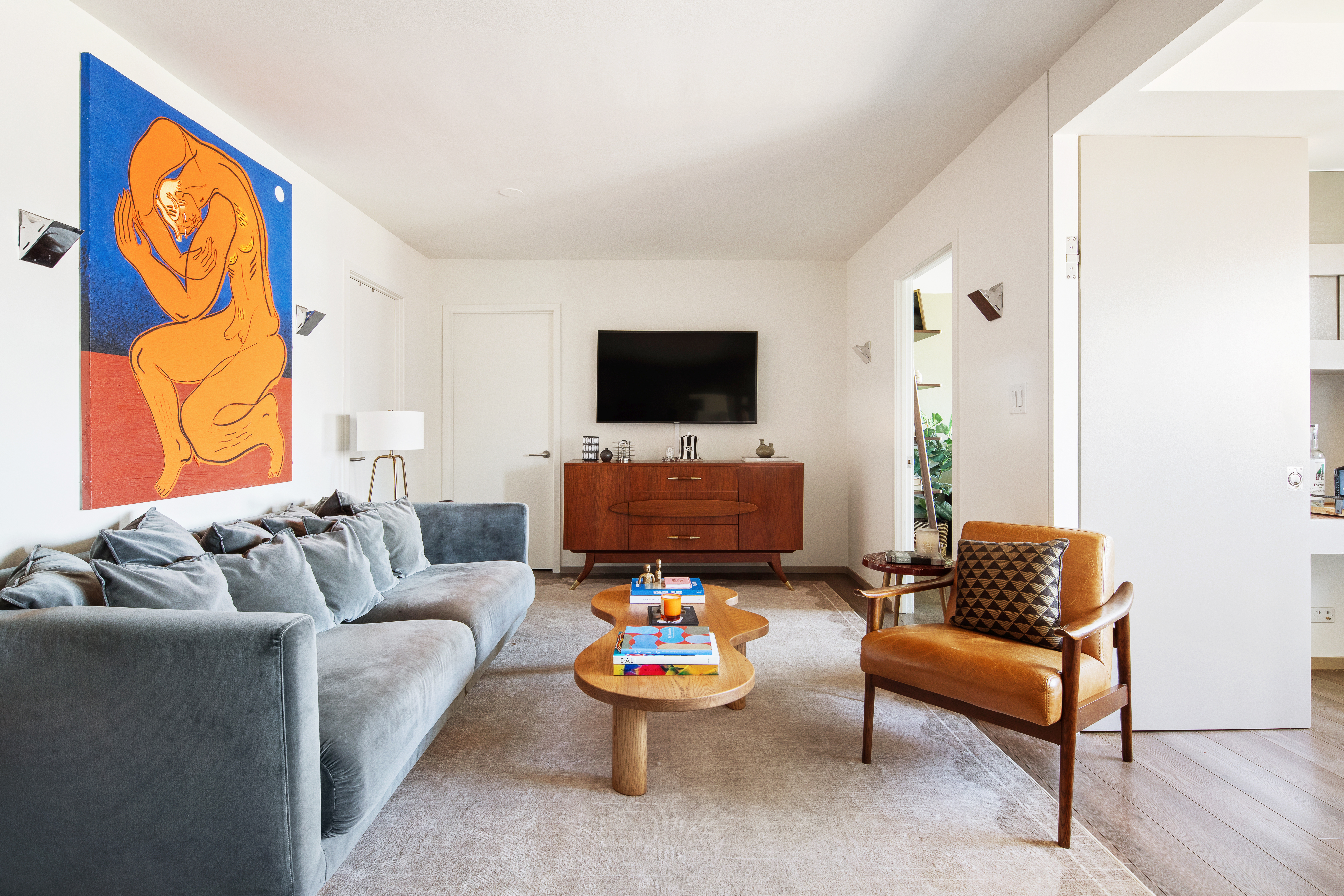 69 West 9th Street, Unit 11CDE Manhattan, NY 10011 - Photo 1 of 9 a living room with furniture and a flat screen tv