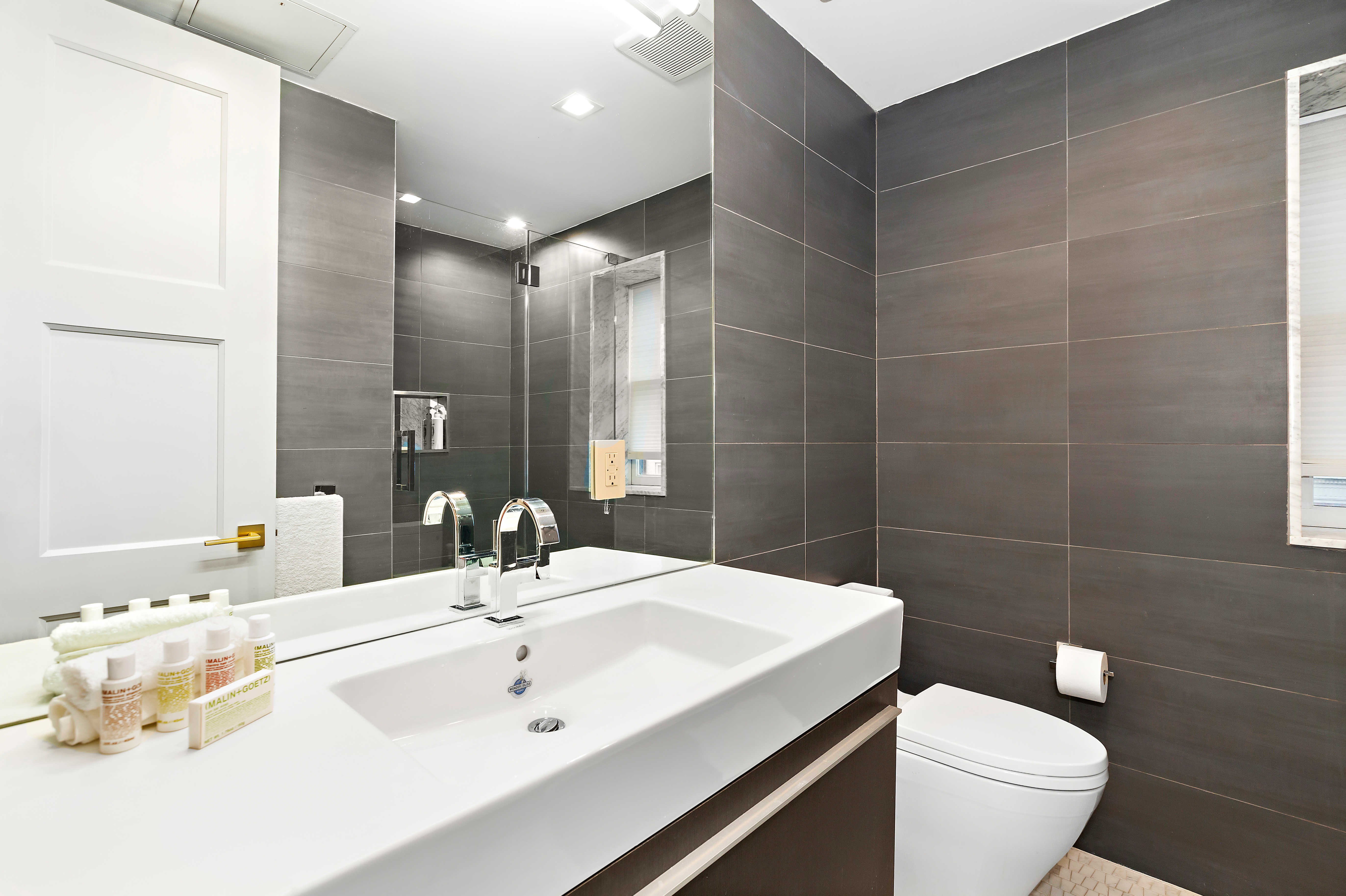 134 East 36th Street Manhattan, NY 10016 - Photo 19 of 28 a bathroom with a sink toilet and shower