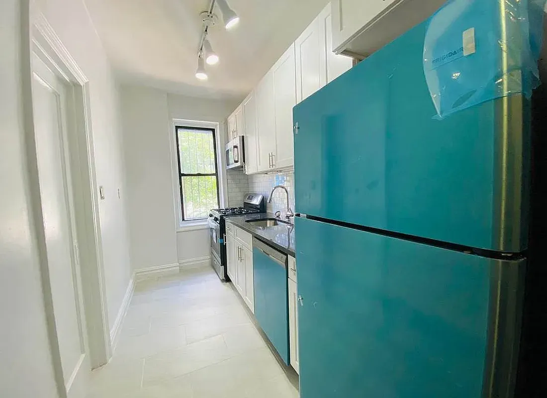 a kitchen with a refrigerator and a stove