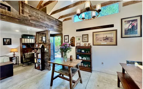 a dining room with furniture and wooden floor
