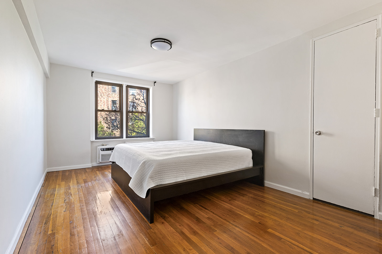 350 Ocean Parkway, Unit 3M Brooklyn, NY 11218 - Photo 7 of 10 a bedroom with a bed and wooden floor