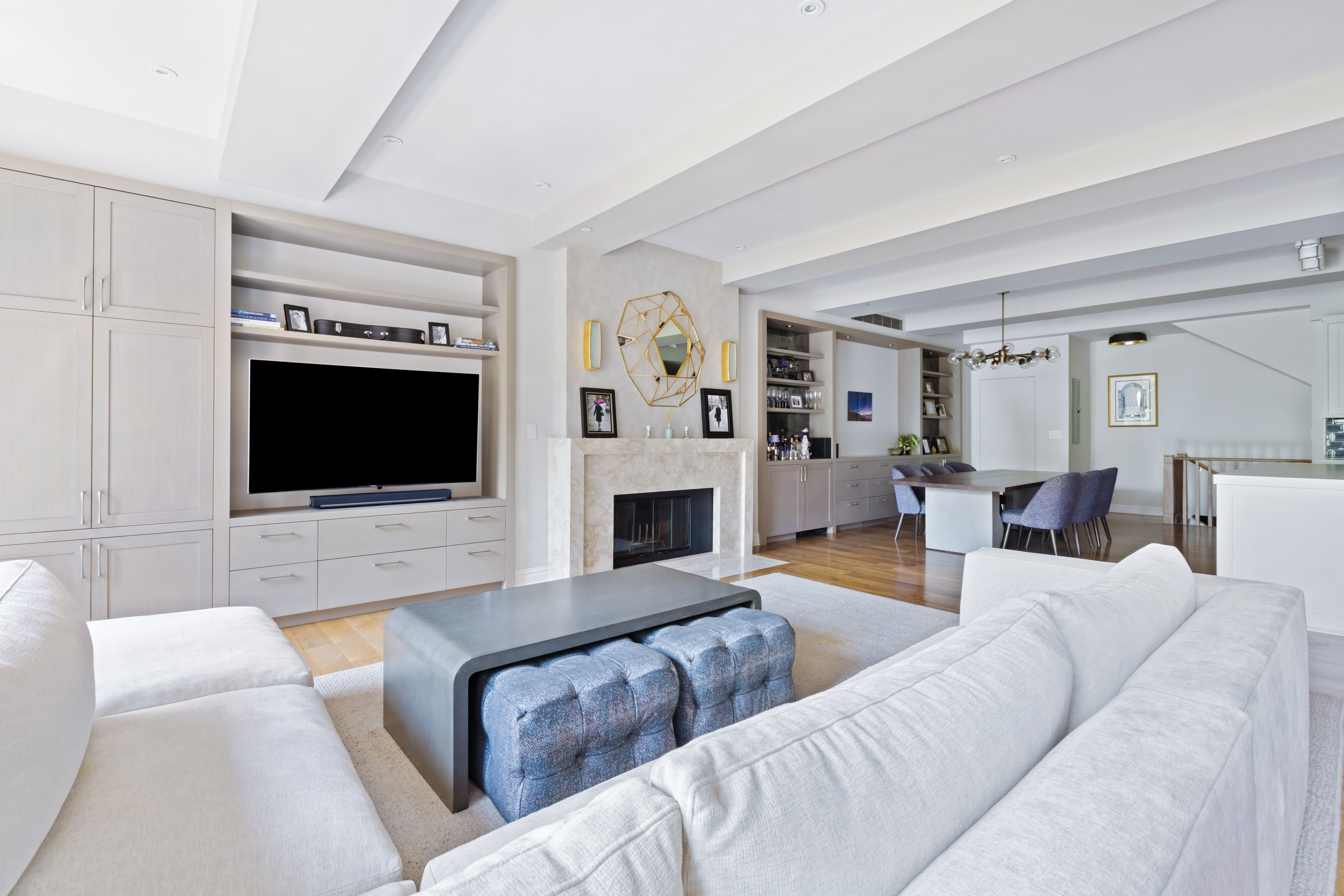 161 Duane Street, Unit 4B Manhattan, NY 10013 - Photo 3 of 12 a living room with furniture a flat screen tv and a fireplace