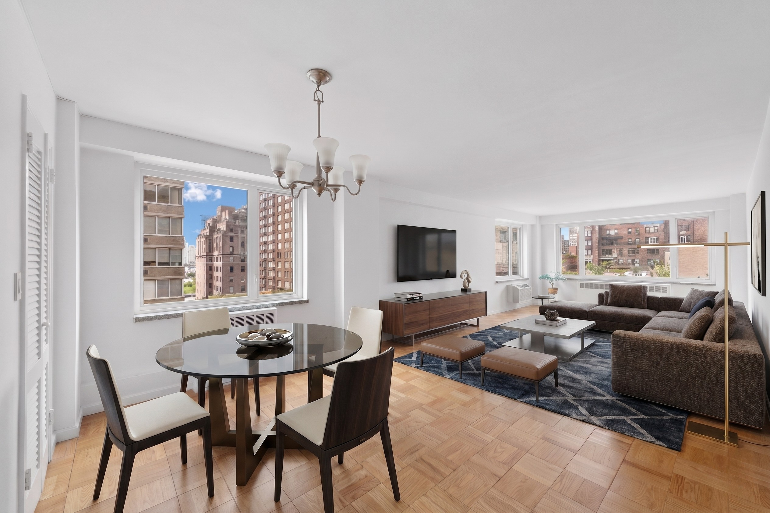 411 East 53rd Street, Unit 16B Manhattan, NY 10022 - Photo 1 of 9 a living room with furniture and a flat screen tv