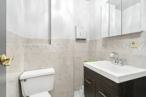 a bathroom with a sink toilet and vanity