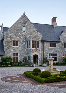 a front view of a house with a yard fire pit and outdoor seating