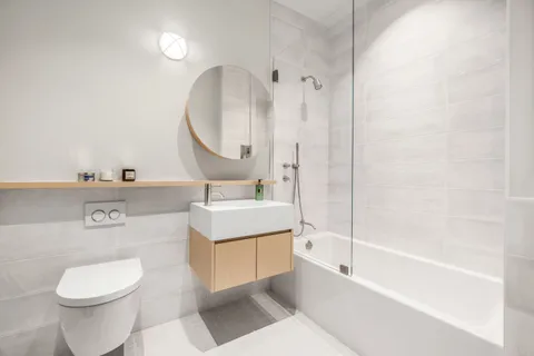 a bathroom with a sink a toilet and a mirror
