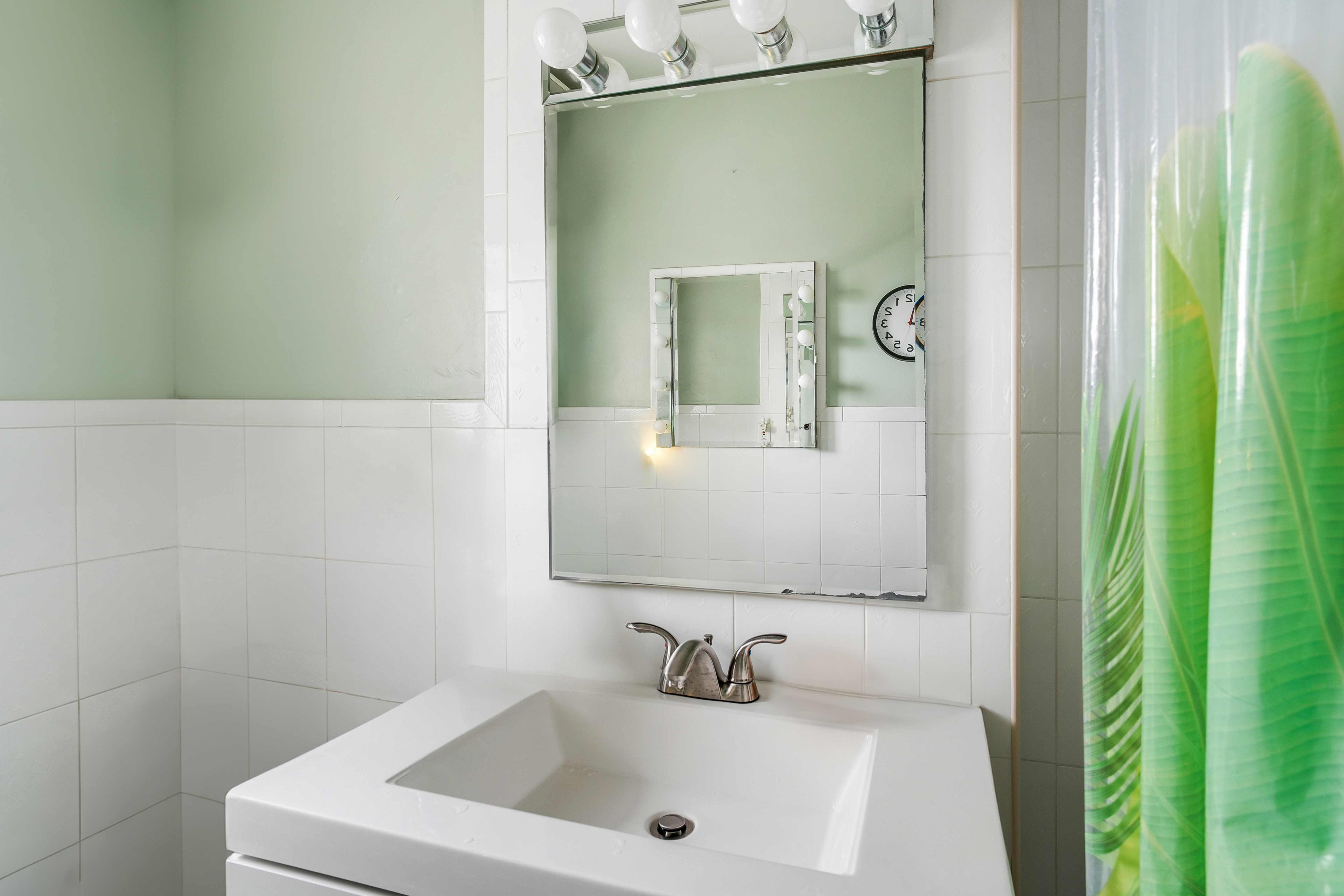 9801 Shore Road, Unit 3E Brooklyn, NY 11209 - Photo 6 of 9 a bathroom with a sink and a mirror