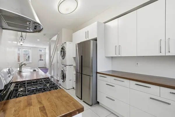a kitchen with refrigerator and window
