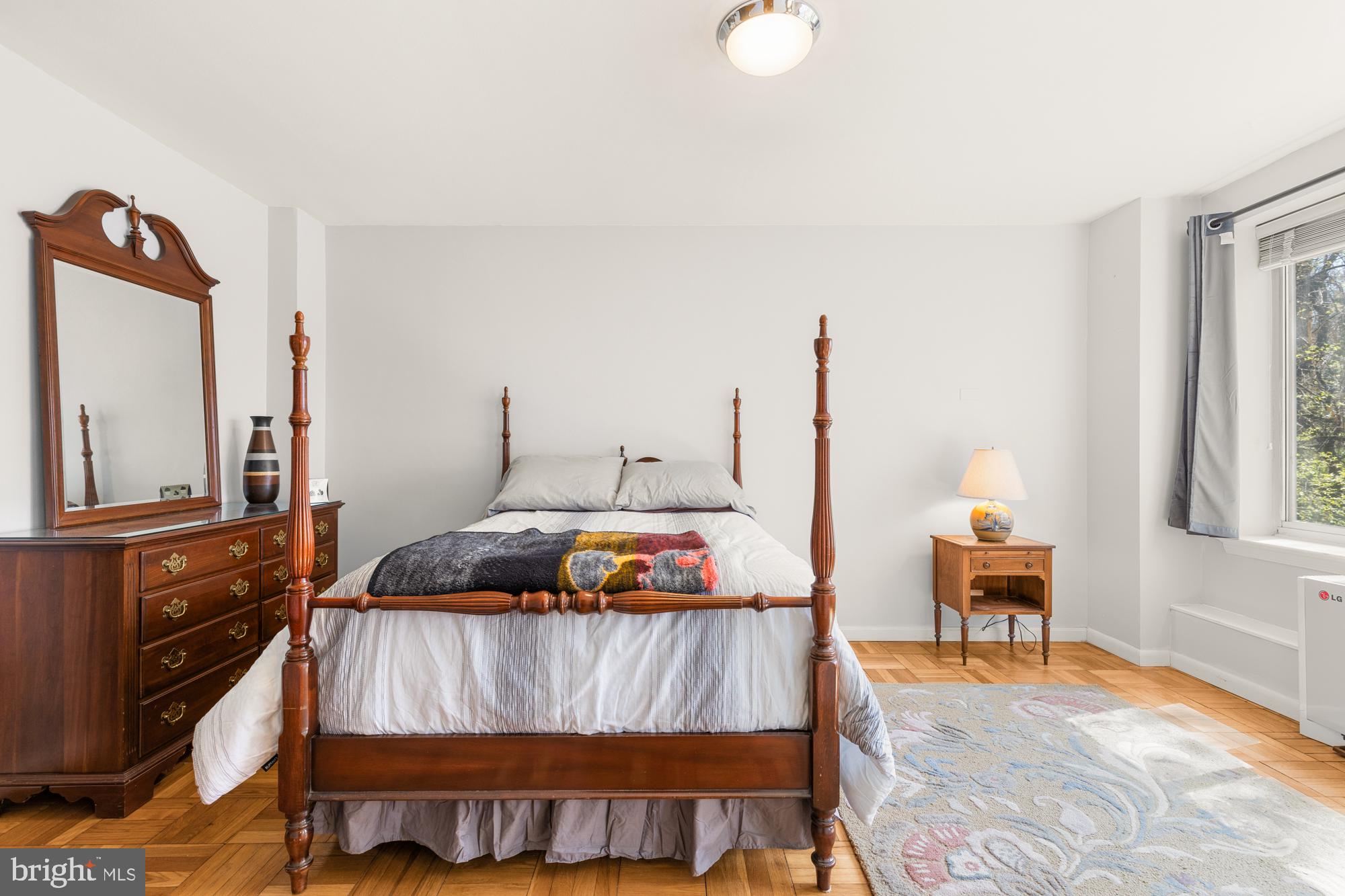 4100 W Street Northwest, Unit 314 Washington, DC 20007 - Photo 19 of 28 a bedroom with a bed and wooden floor