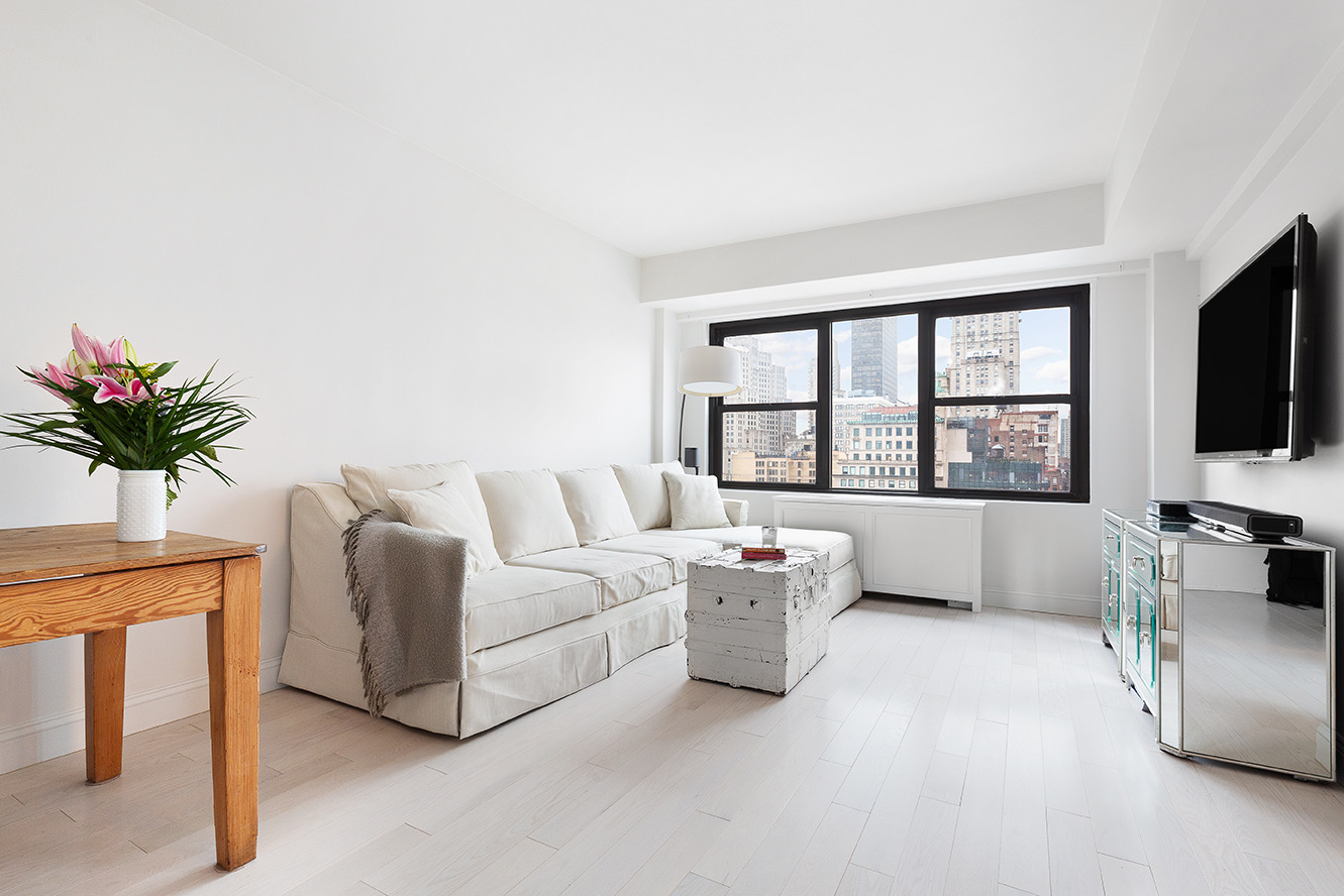 a living room with furniture and a flat screen tv