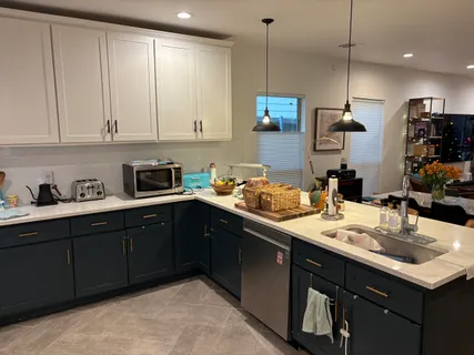 a kitchen with kitchen island granite countertop a sink a stove and cabinets