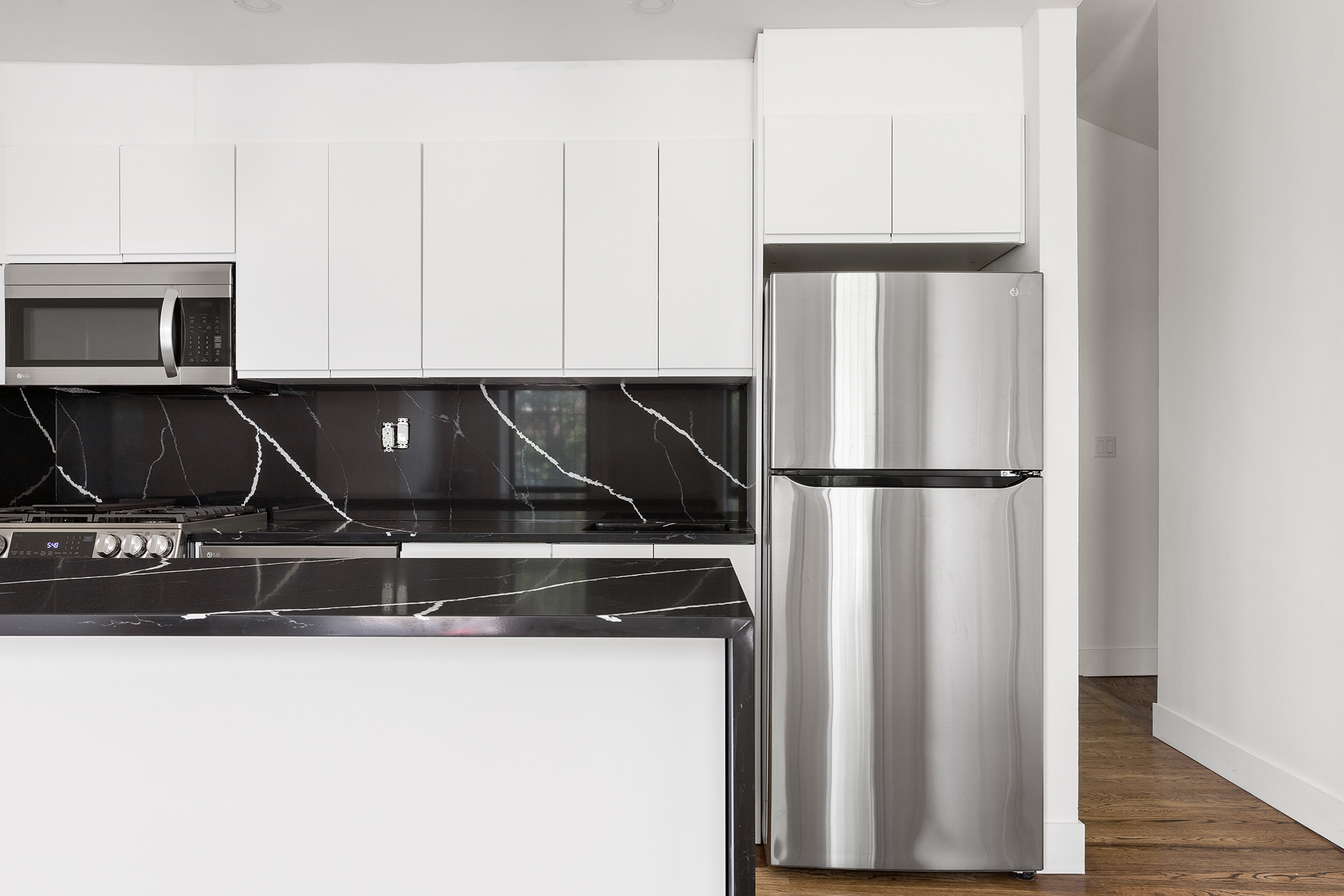 306 Gates Avenue, Unit 1A Brooklyn, NY 11216 - Photo 13 of 14 a kitchen with a refrigerator and a sink