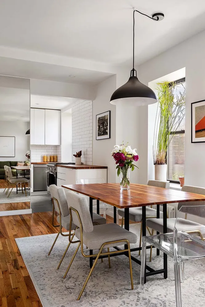 a dining room with furniture window and wooden floor