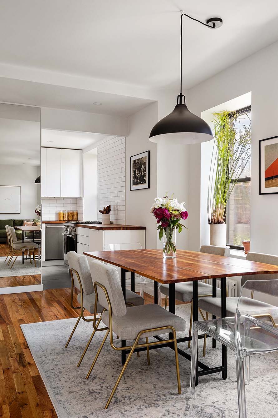 a dining room with furniture window and wooden floor