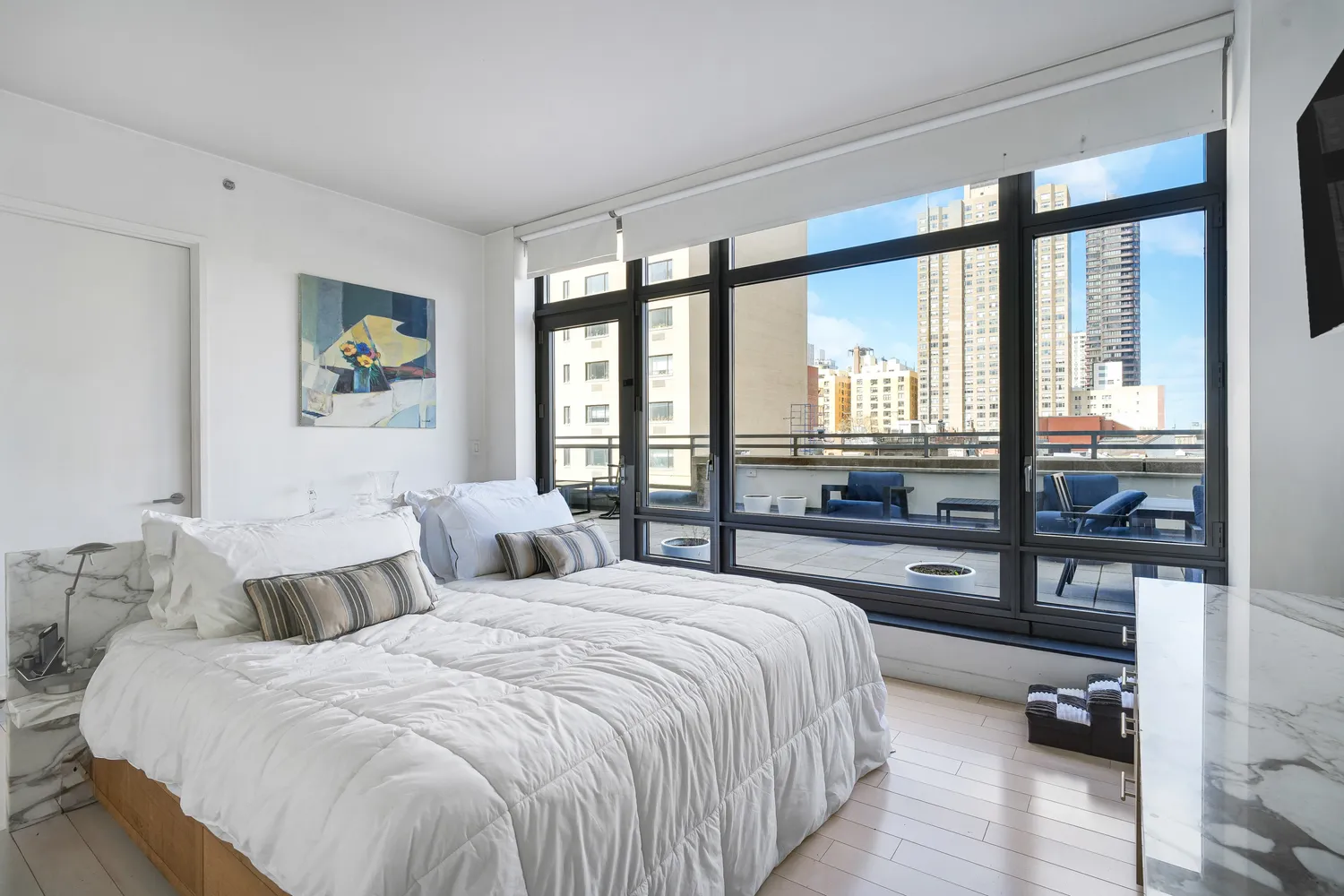 a bedroom with a bed and a large window