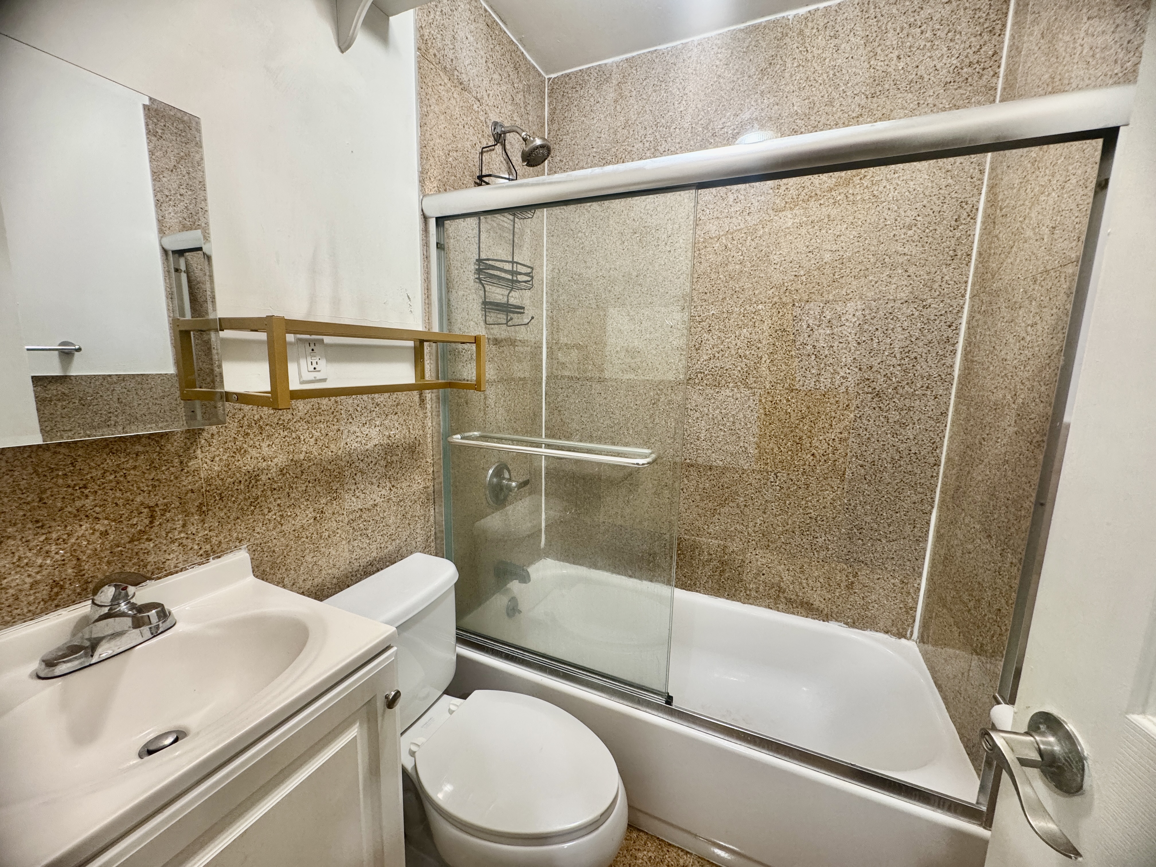 1773 1st Avenue, Unit 18 Manhattan, NY 10128 - Photo 7 of 10 a bathroom with a sink toilet and shower