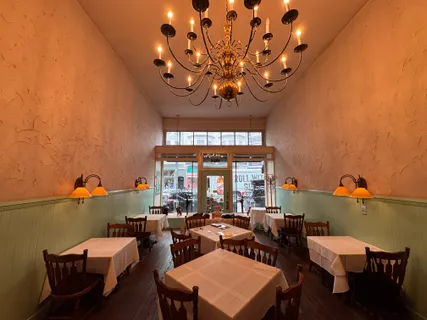 a view of a dining room with furniture and chandelier