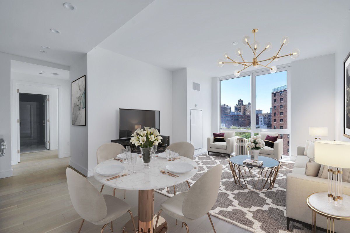 a dining room with furniture a rug and a chandelier