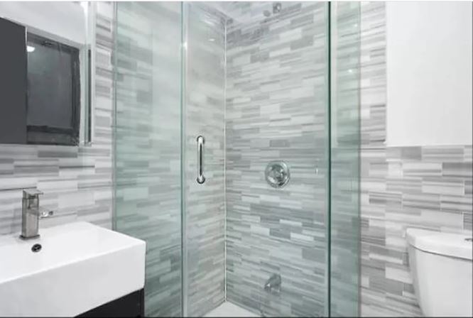 943 Columbus Avenue, Unit 2C Manhattan, NY 10025 - Photo 4 of 5 a bathroom with a sink and shower