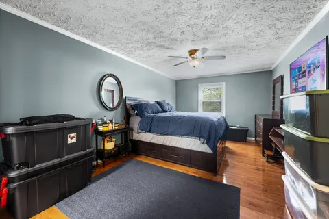 a bedroom with furniture and a flat screen tv