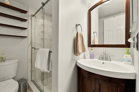 a bathroom with a sink toilet and shower