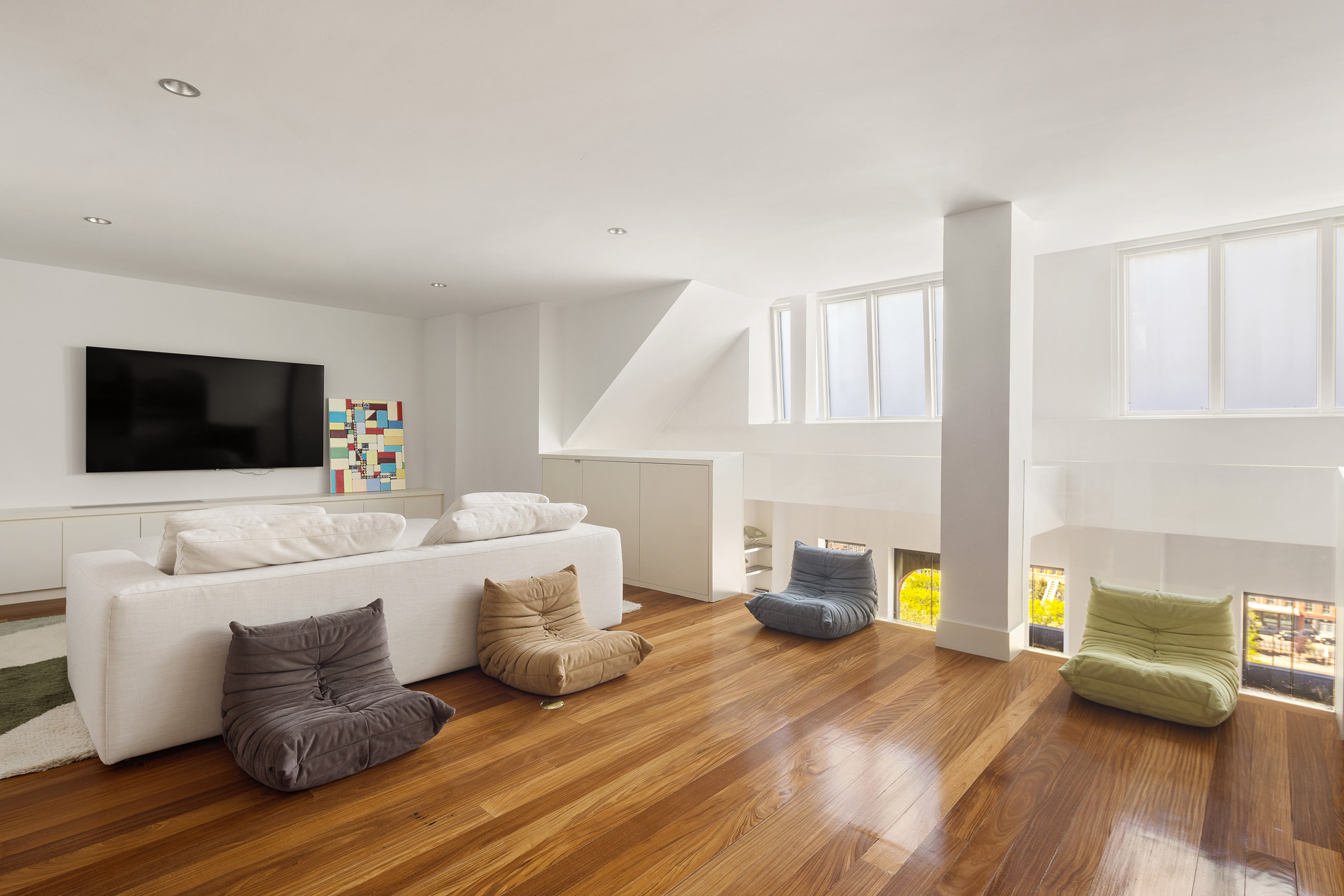 27 North Moore Street, Unit 10D Manhattan, NY 10013 - Photo 23 of 30 a living room with furniture and a flat screen tv