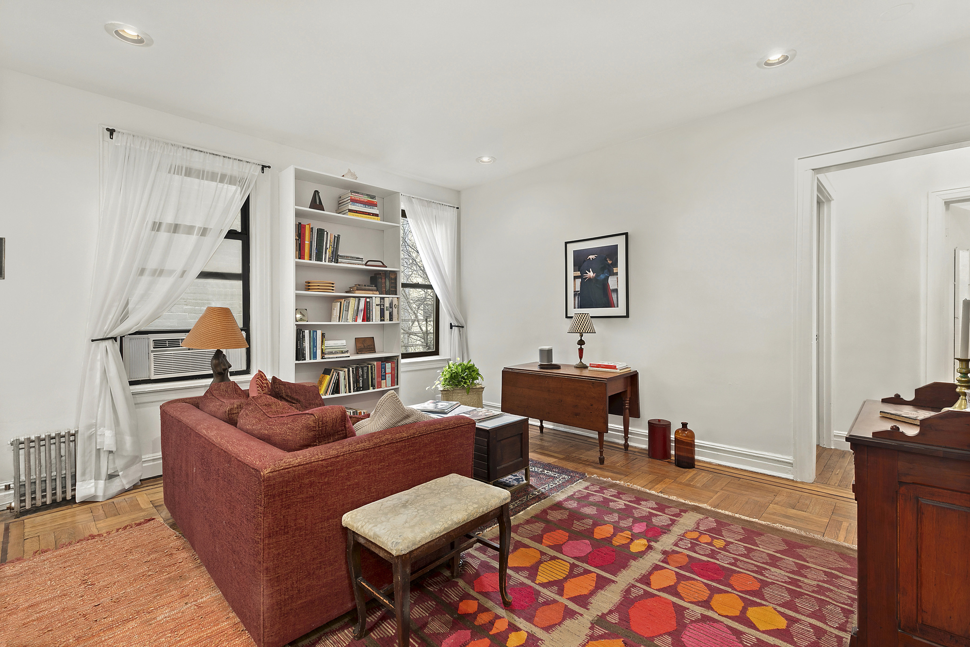 a living room with furniture a rug and a window