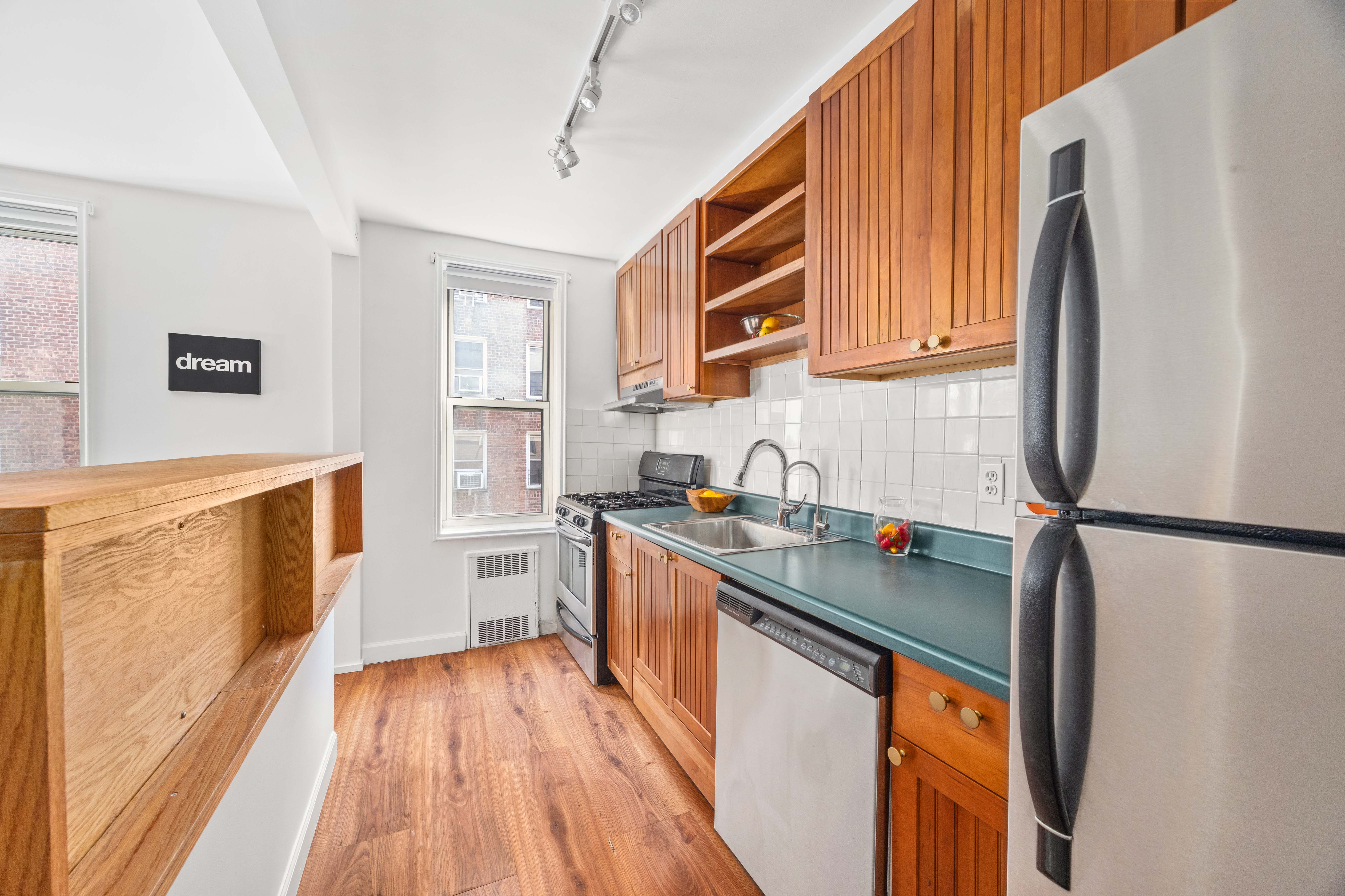 221 McDonald Avenue, Unit 2R Brooklyn, NY 11218 - Photo 3 of 8 a kitchen with stainless steel appliances a refrigerator sink and wooden floor