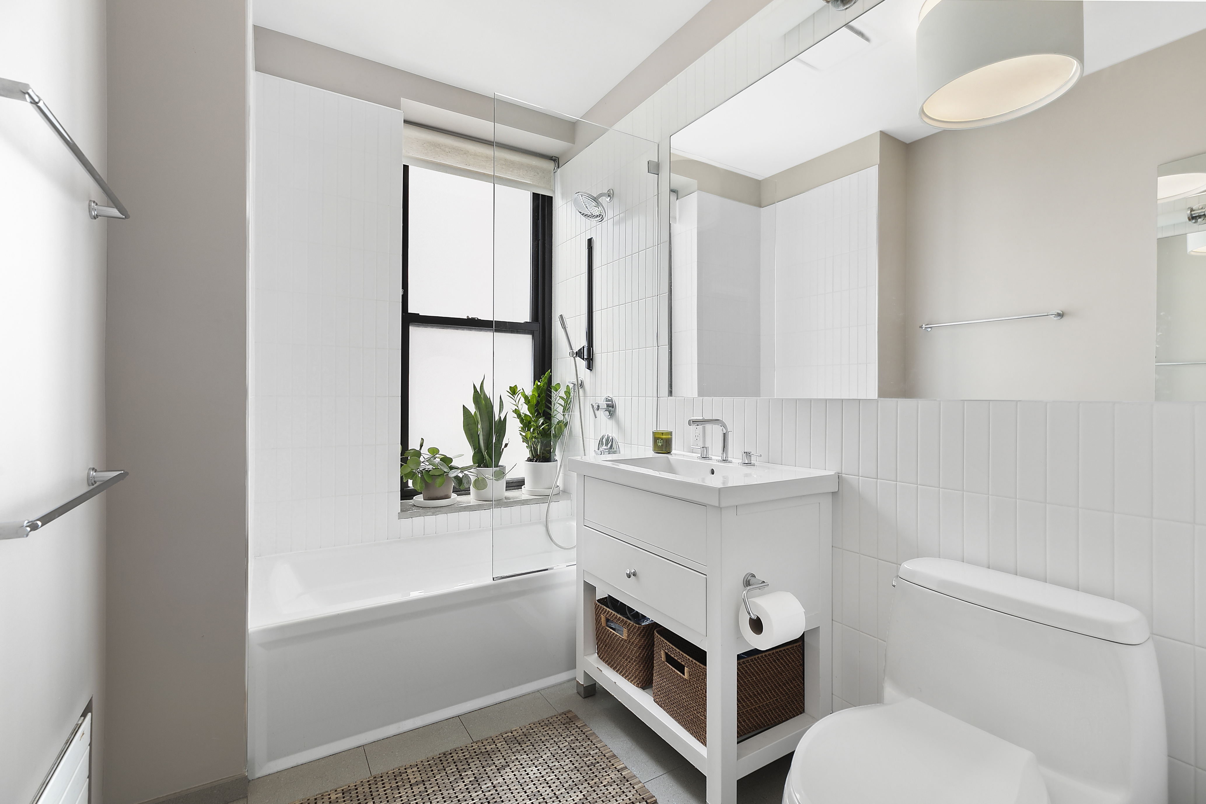 422 West 20th Street, Unit 5A Manhattan, NY 10011 - Photo 8 of 14 a bathroom with a sink a toilet and tub
