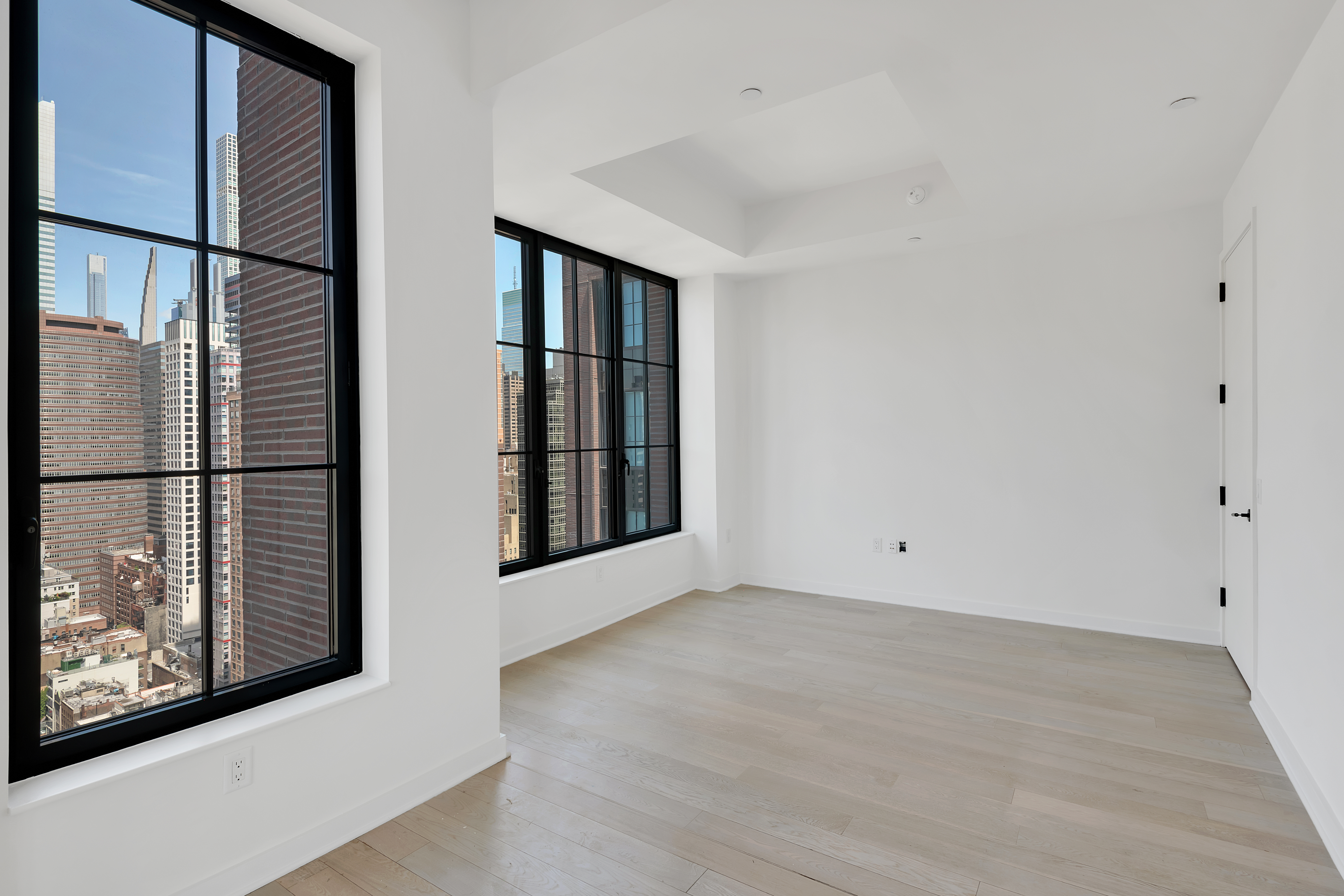 959 1st Avenue, Unit 25H Manhattan, NY 10022 - Photo 4 of 18 a view of an empty room with wooden floor and a window