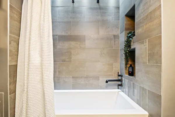 a bathroom with a bathtub and shower
