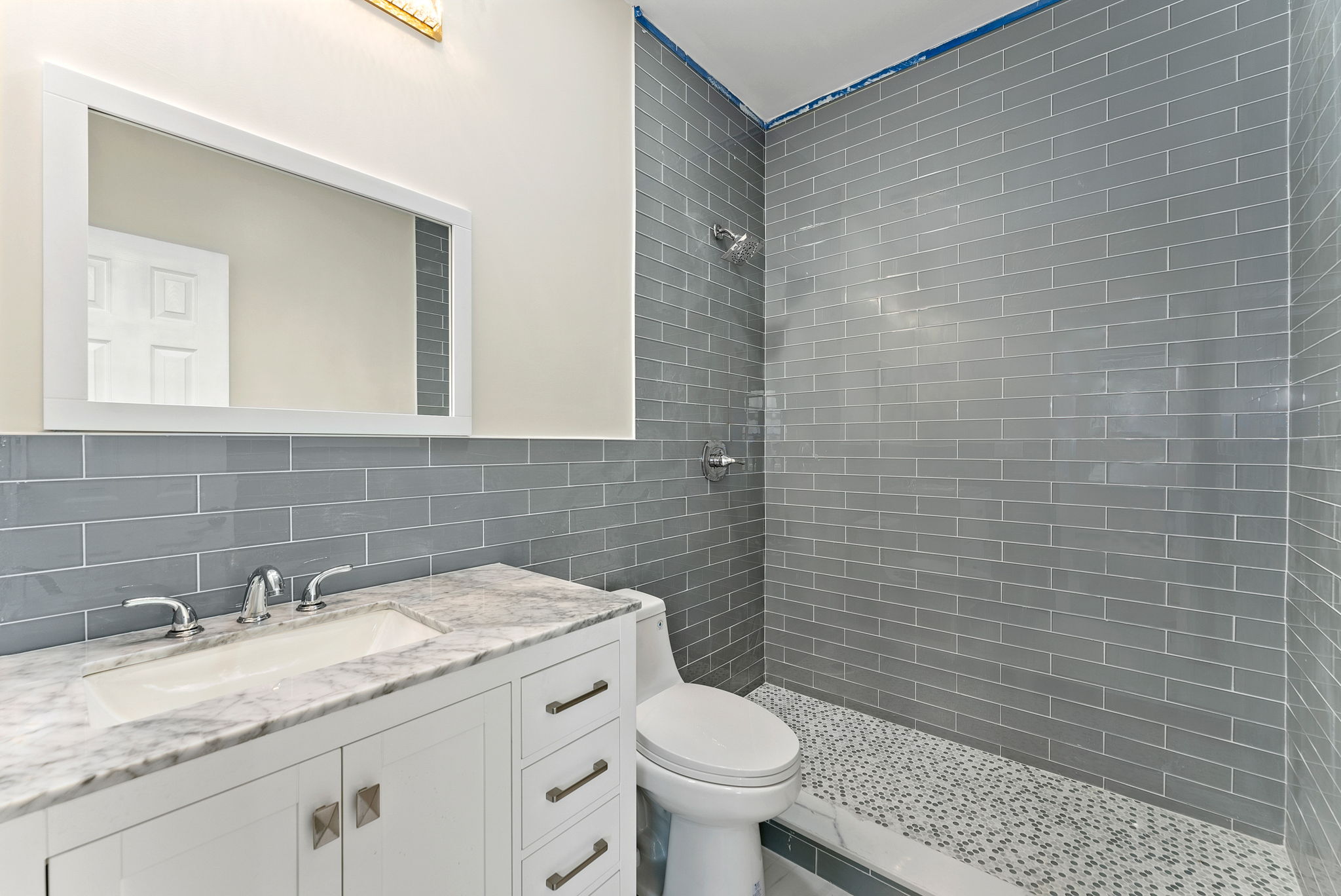 217 Butler Street, Unit 1 Brooklyn, NY 11217 - Photo 5 of 10 a bathroom with a granite countertop toilet sink and mirror