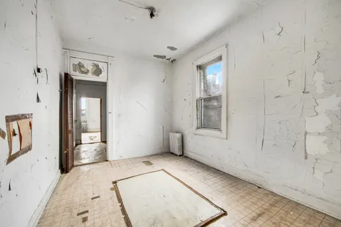 an empty room with windows and closet