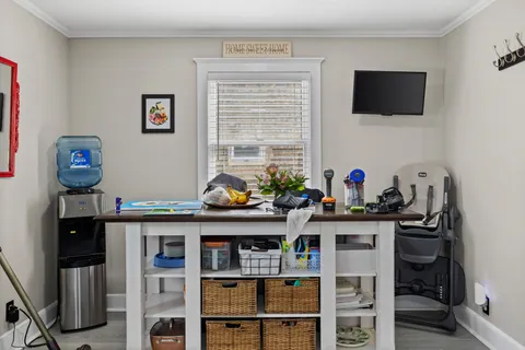 a room with furniture a flat screen tv and a window