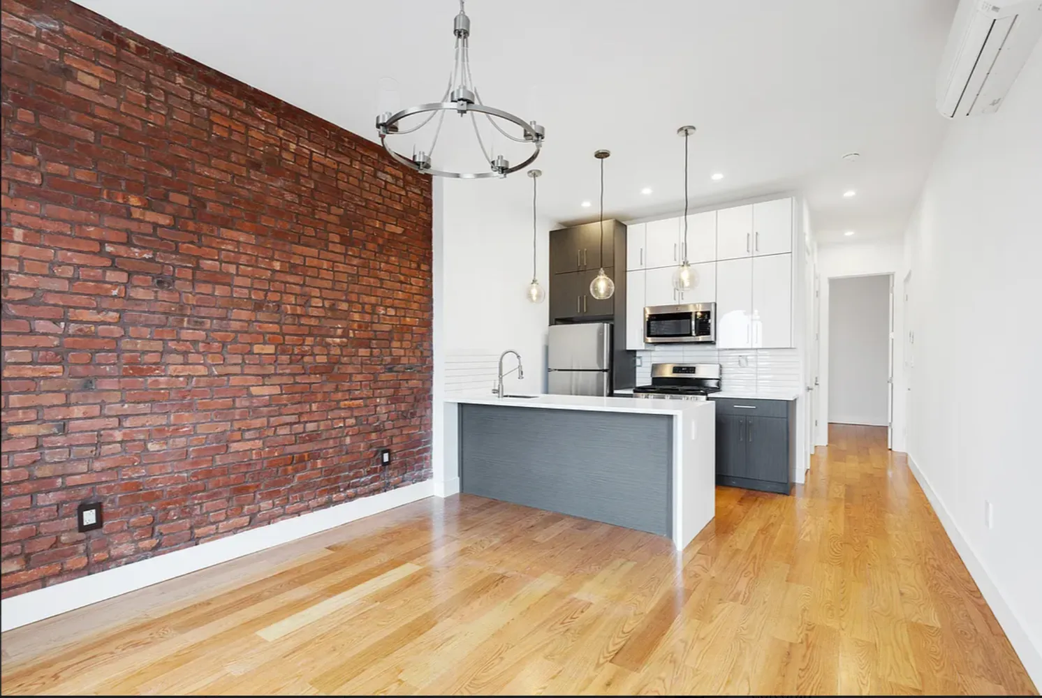 a large kitchen with stainless steel appliances kitchen island granite countertop a sink a counter space and cabinets