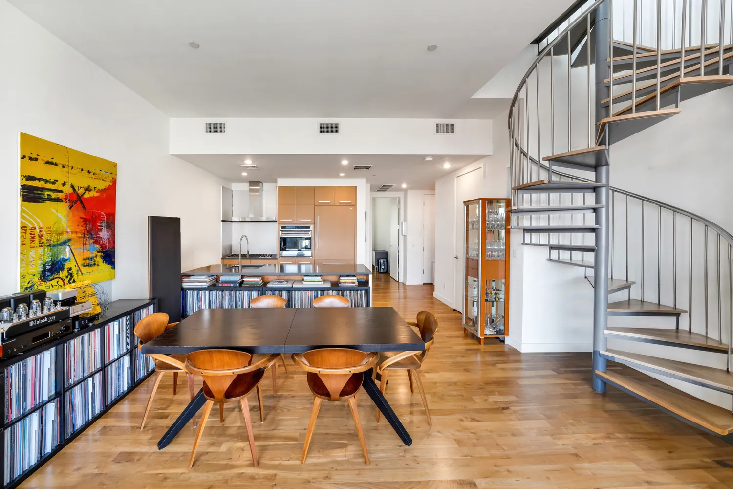 a dining room with furniture and wooden floor