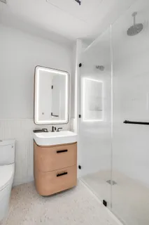 a bathroom with a sink toilet and shower