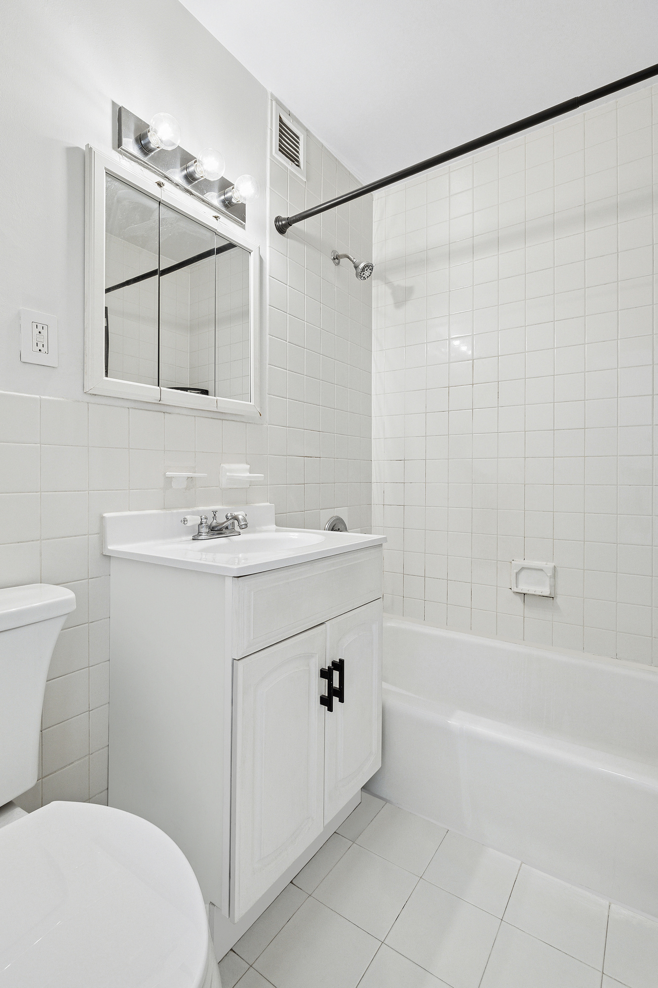 61 Lexington Avenue, Unit 5F Manhattan, NY 10010 - Photo 5 of 6 a bathroom with a sink a toilet and shower
