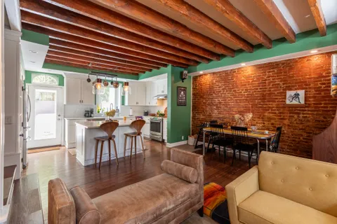 a dining room with furniture and a floor to ceiling window