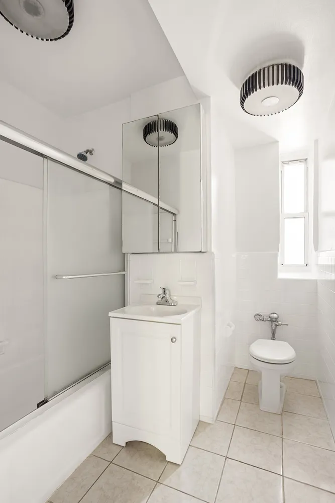 a bathroom with a sink a toilet and a mirror