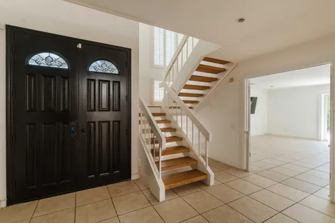 a view of entryway with stairs and wooden floor