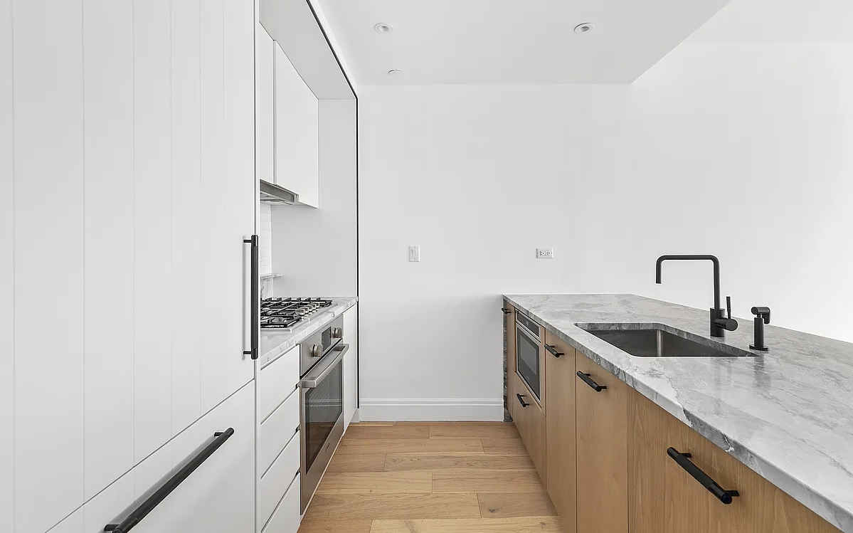 181 18th Street, Unit 408 Brooklyn, NY 11215 - Photo 2 of 13 a kitchen with granite countertop a sink and stainless steel appliances