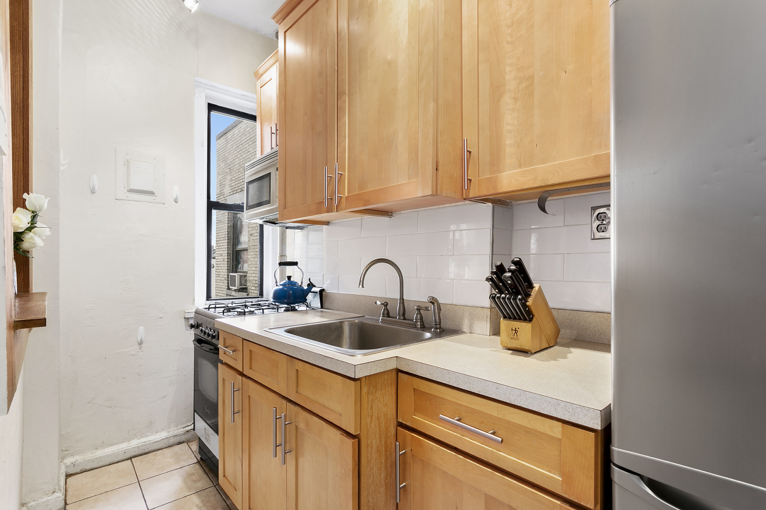 544 West 157th Street, Unit 85 Manhattan, NY 10032 - Photo 2 of 6 a kitchen with a sink and cabinets